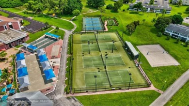 WATER VIEW! Indulge in this luxury 2 bed, 2 bath condo nestled on Hillsboro Pines Golf in Florida - for sale on GolfHomes.com, golf home, golf lot