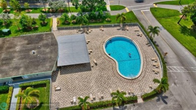 WATER VIEW! Indulge in this luxury 2 bed, 2 bath condo nestled on Hillsboro Pines Golf in Florida - for sale on GolfHomes.com, golf home, golf lot