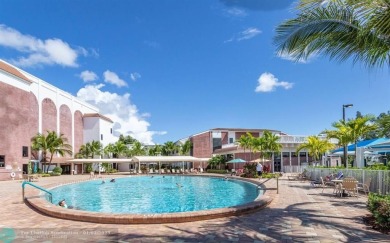 WATER VIEW! Indulge in this luxury 2 bed, 2 bath condo nestled on Hillsboro Pines Golf in Florida - for sale on GolfHomes.com, golf home, golf lot