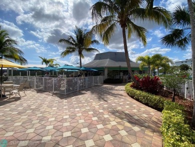 WATER VIEW! Indulge in this luxury 2 bed, 2 bath condo nestled on Hillsboro Pines Golf in Florida - for sale on GolfHomes.com, golf home, golf lot