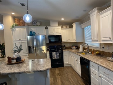 THIS 2018 CHAMPION HOME OFFERS ALL THE LUXURY MUST HAVES on Silver Dollar Golf and Trap Club in Florida - for sale on GolfHomes.com, golf home, golf lot