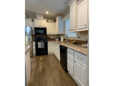 THIS 2018 CHAMPION HOME OFFERS ALL THE LUXURY MUST HAVES on Silver Dollar Golf and Trap Club in Florida - for sale on GolfHomes.com, golf home, golf lot