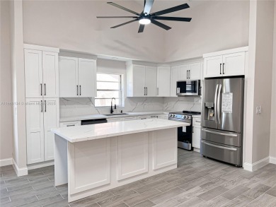 Welcome to your Florida oasis! This fully renovated and spacious on Cypress Lakes Golf Course - West Palm Beach in Florida - for sale on GolfHomes.com, golf home, golf lot
