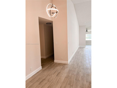 Welcome to your Florida oasis! This fully renovated and spacious on Cypress Lakes Golf Course - West Palm Beach in Florida - for sale on GolfHomes.com, golf home, golf lot