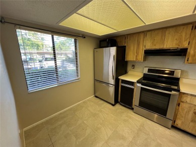 Welcome to this inviting first-floor, 2-bedroom, 2-bath condo in on East Lake Woodlands Country Club in Florida - for sale on GolfHomes.com, golf home, golf lot