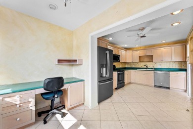 Experience timeless comfort and sweeping double fairway views in on Quail Ridge Golf Course and Country Club in Florida - for sale on GolfHomes.com, golf home, golf lot