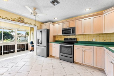 Experience timeless comfort and sweeping double fairway views in on Quail Ridge Golf Course and Country Club in Florida - for sale on GolfHomes.com, golf home, golf lot