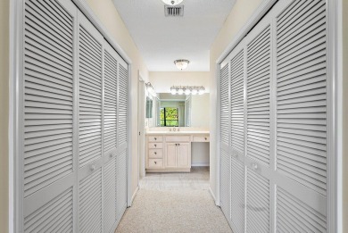Experience timeless comfort and sweeping double fairway views in on Quail Ridge Golf Course and Country Club in Florida - for sale on GolfHomes.com, golf home, golf lot