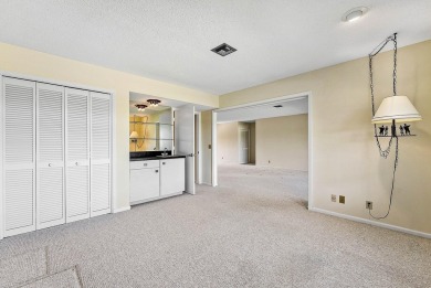 Experience timeless comfort and sweeping double fairway views in on Quail Ridge Golf Course and Country Club in Florida - for sale on GolfHomes.com, golf home, golf lot