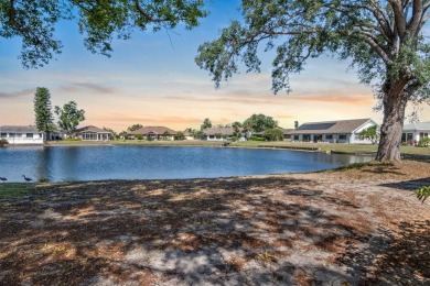 Nestled on a serene cul-de-sac with picturesque lake views, this on Caloosa Greens Executive Golf Course in Florida - for sale on GolfHomes.com, golf home, golf lot