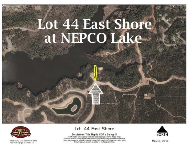 Over 60' of frontage on beautiful NEPCO Lake. This wooded lot on The Ridges Golf Club in Wisconsin - for sale on GolfHomes.com, golf home, golf lot