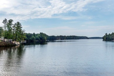 Over 60' of frontage on beautiful NEPCO Lake. This wooded lot on The Ridges Golf Club in Wisconsin - for sale on GolfHomes.com, golf home, golf lot