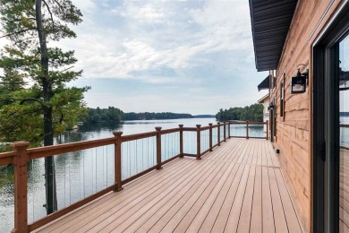 Over 60' of frontage on beautiful NEPCO Lake. This wooded lot on The Ridges Golf Club in Wisconsin - for sale on GolfHomes.com, golf home, golf lot