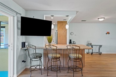 Experience the perfect blend of coastal charm and modern comfort on Gulf Harbors Golf Course in Florida - for sale on GolfHomes.com, golf home, golf lot