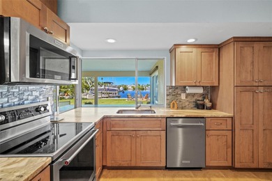 Experience the perfect blend of coastal charm and modern comfort on Gulf Harbors Golf Course in Florida - for sale on GolfHomes.com, golf home, golf lot