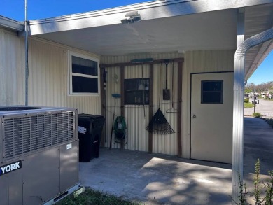 Discover easy Florida living in this 2-bedroom, 2-bath home on Lake Henry Golf Club in Florida - for sale on GolfHomes.com, golf home, golf lot