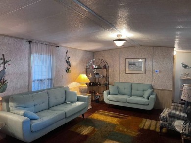 Discover easy Florida living in this 2-bedroom, 2-bath home on Lake Henry Golf Club in Florida - for sale on GolfHomes.com, golf home, golf lot