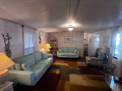 Discover easy Florida living in this 2-bedroom, 2-bath home on Lake Henry Golf Club in Florida - for sale on GolfHomes.com, golf home, golf lot