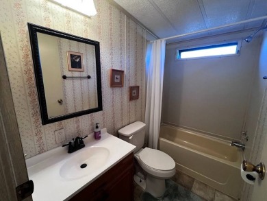 Discover easy Florida living in this 2-bedroom, 2-bath home on Lake Henry Golf Club in Florida - for sale on GolfHomes.com, golf home, golf lot