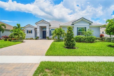 This newly built, elegant pool home backs to a serene lake on Bent Pine Golf Club in Florida - for sale on GolfHomes.com, golf home, golf lot