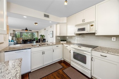 GORGEOUS & nestled on the golf greens with peaceful views, this on Isla Del Sol Yacht and Country Club in Florida - for sale on GolfHomes.com, golf home, golf lot