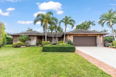 This beautiful CBS home with cedar wood siding is in a lovely on West Palm Beach Golf Course in Florida - for sale on GolfHomes.com, golf home, golf lot