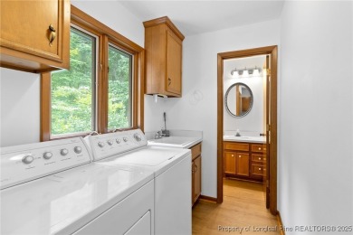 Welcome to a beautifully, partially updated brick home nestled on Carolina Trace Country Club in North Carolina - for sale on GolfHomes.com, golf home, golf lot