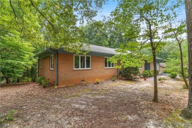 Welcome to a beautifully, partially updated brick home nestled on Carolina Trace Country Club in North Carolina - for sale on GolfHomes.com, golf home, golf lot