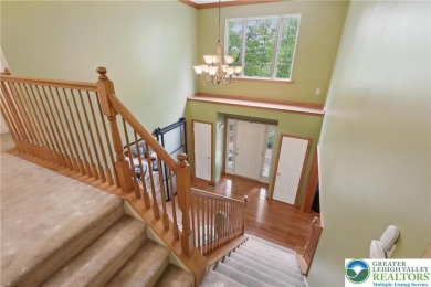 Perched atop a scenic hilltop, 136 Outlook Court offers a unique on Country Club of the Poconos Golf Course in Pennsylvania - for sale on GolfHomes.com, golf home, golf lot