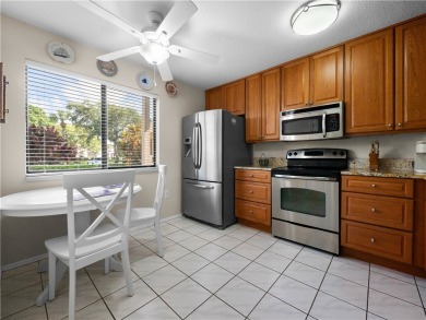 First floor unit with a lake view. 42* kitchen cabinets, granite on Pelican Pointe 9 Hole Course in Florida - for sale on GolfHomes.com, golf home, golf lot