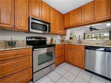 First floor unit with a lake view. 42* kitchen cabinets, granite on Pelican Pointe 9 Hole Course in Florida - for sale on GolfHomes.com, golf home, golf lot