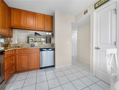 First floor unit with a lake view. 42* kitchen cabinets, granite on Pelican Pointe 9 Hole Course in Florida - for sale on GolfHomes.com, golf home, golf lot