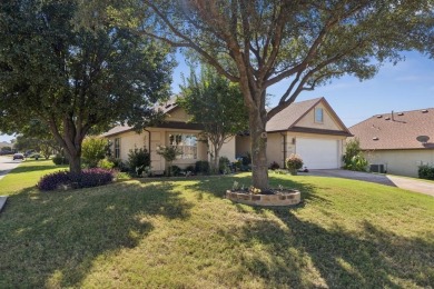 Nestled in a beautifully landscaped setting and shaded by mature on Wildhorse Golf Club of Robson Ranch in Texas - for sale on GolfHomes.com, golf home, golf lot