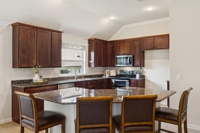 Nestled in a beautifully landscaped setting and shaded by mature on Wildhorse Golf Club of Robson Ranch in Texas - for sale on GolfHomes.com, golf home, golf lot