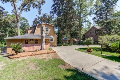 Welcome to your unique Dutch Colonial-style waterfront oasis in on Mississippi National Golf Course in Mississippi - for sale on GolfHomes.com, golf home, golf lot