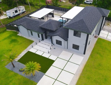 Prepare to be wowed by this magnificent 2-story home on an on Okeeheelee Golf Course in Florida - for sale on GolfHomes.com, golf home, golf lot