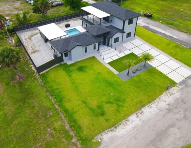 Prepare to be wowed by this magnificent 2-story home on an on Okeeheelee Golf Course in Florida - for sale on GolfHomes.com, golf home, golf lot