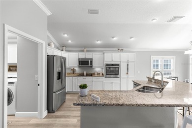 *NEW ROOF (2024)* *GOLF-CART GARAGE* * SOLAR HEATED PRIVATE on Bella Glade Country Club in Florida - for sale on GolfHomes.com, golf home, golf lot