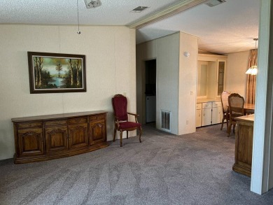 This home needs a little TLC and is priced at $25,000 for a on Pine Lakes Country Club in Florida - for sale on GolfHomes.com, golf home, golf lot