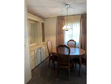 This home needs a little TLC and is priced at $25,000 for a on Pine Lakes Country Club in Florida - for sale on GolfHomes.com, golf home, golf lot