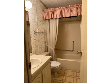 This home needs a little TLC and is priced at $25,000 for a on Pine Lakes Country Club in Florida - for sale on GolfHomes.com, golf home, golf lot