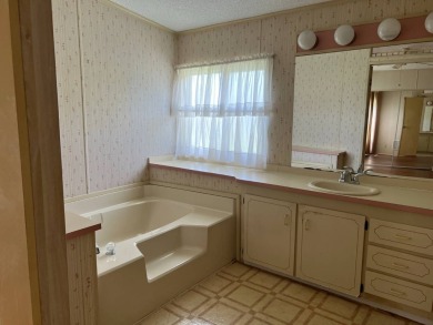 This home needs a little TLC and is priced at $25,000 for a on Pine Lakes Country Club in Florida - for sale on GolfHomes.com, golf home, golf lot
