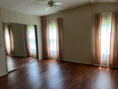 This home needs a little TLC and is priced at $25,000 for a on Pine Lakes Country Club in Florida - for sale on GolfHomes.com, golf home, golf lot