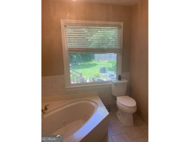 This ranch home is happily situated on a beautiful 1.03-acre lot on Honey Creek Country Club in Georgia - for sale on GolfHomes.com, golf home, golf lot