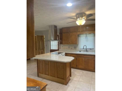 This ranch home is happily situated on a beautiful 1.03-acre lot on Honey Creek Country Club in Georgia - for sale on GolfHomes.com, golf home, golf lot