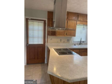 This ranch home is happily situated on a beautiful 1.03-acre lot on Honey Creek Country Club in Georgia - for sale on GolfHomes.com, golf home, golf lot