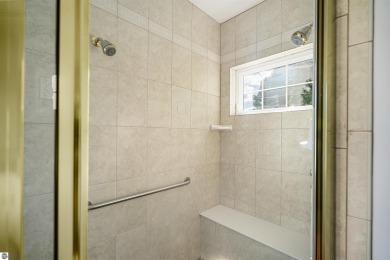 Experience luxury living on the 11th fairway of The Bear Golf on Grand Traverse Resort and Spa in Michigan - for sale on GolfHomes.com, golf home, golf lot