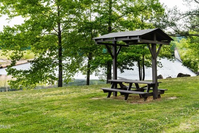 Beautiful 0.49-acre wooded lot located in the gated Lake Royale on River Golf and Country Club at Lake Royale in North Carolina - for sale on GolfHomes.com, golf home, golf lot