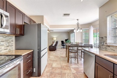 Welcome to this lovingly maintained 4-bedroom, 2.5-bath home on Hunters Green Country Club in Florida - for sale on GolfHomes.com, golf home, golf lot