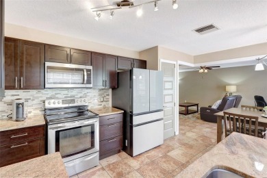 Welcome to this lovingly maintained 4-bedroom, 2.5-bath home on Hunters Green Country Club in Florida - for sale on GolfHomes.com, golf home, golf lot